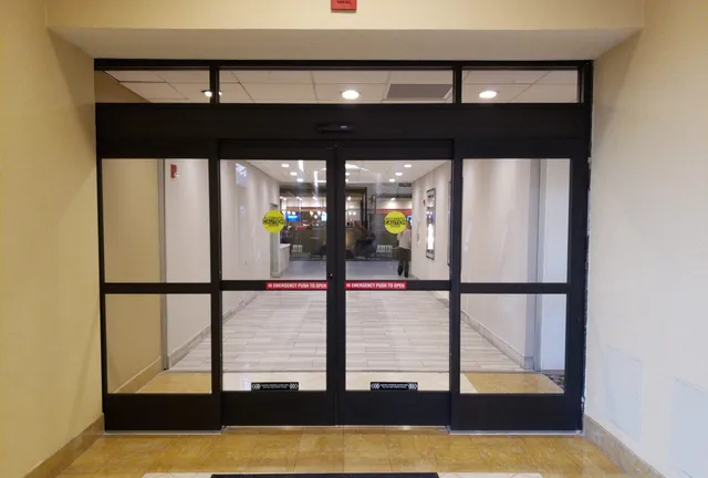 Automatic sliding entrance doors open in a commercial lobby