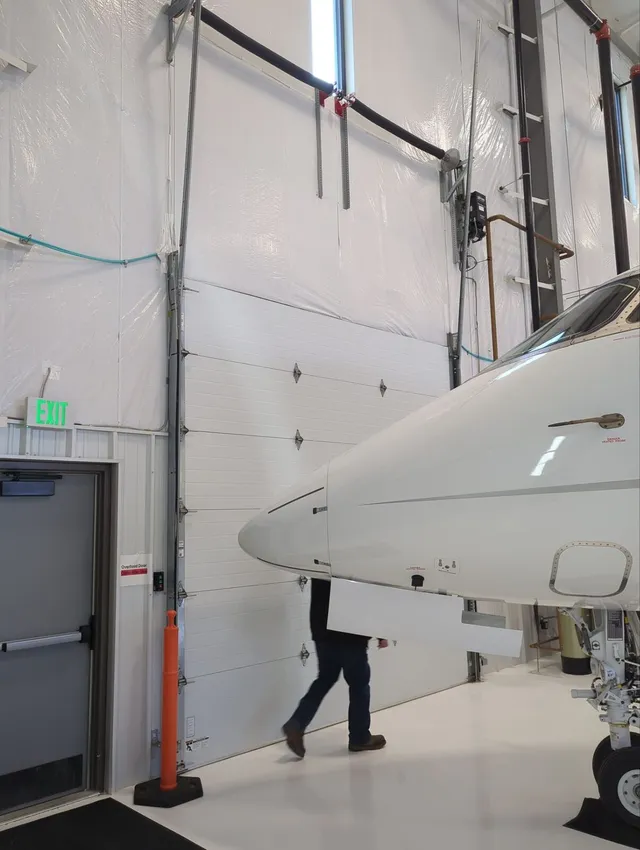 Sectional hangar door interior with aircraft nose visible
