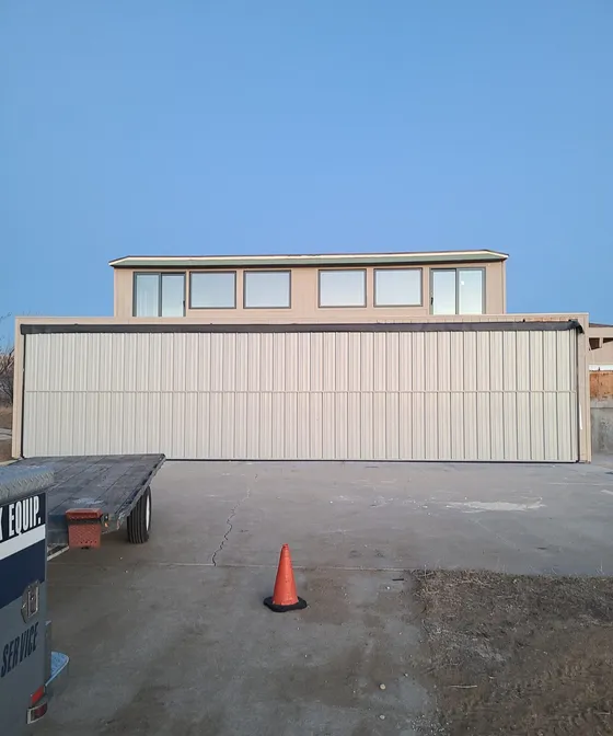 Completed bifold hangar door installation, closed