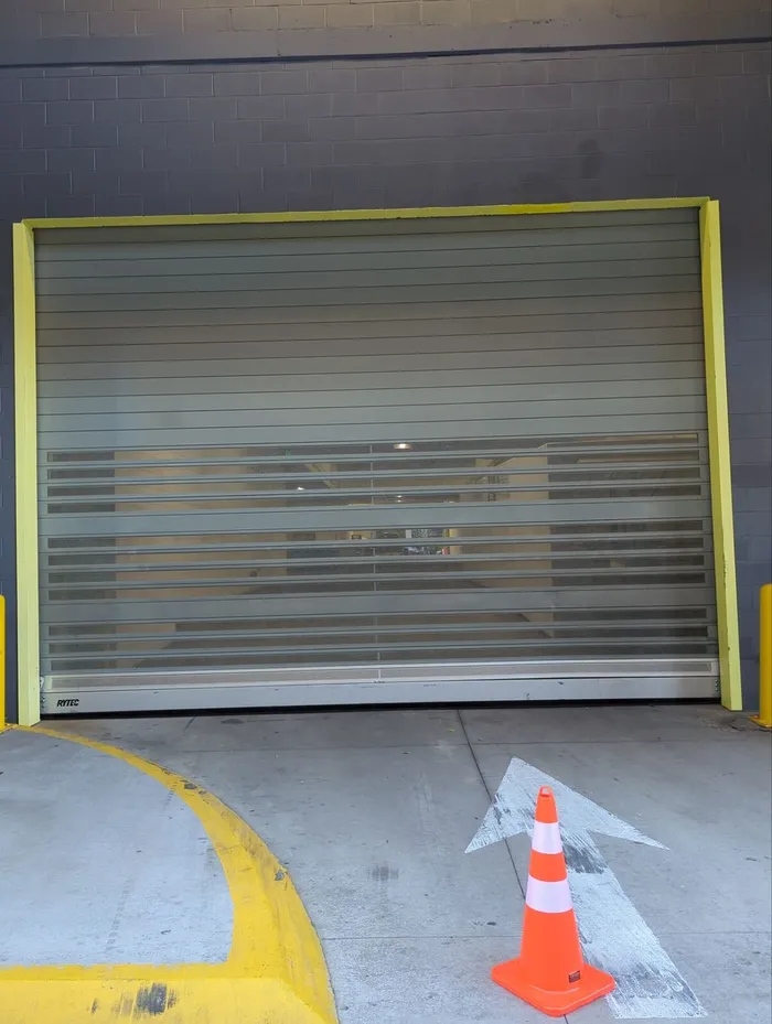 Damaged high-speed door curtain before repair
