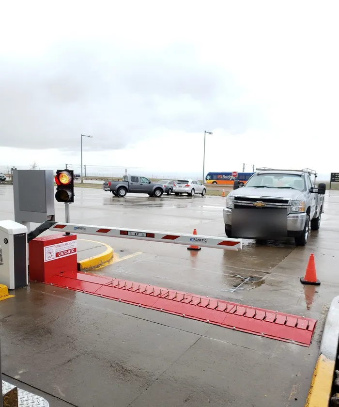 Repaired traffic control barrier and tire spike system at a facility entrance